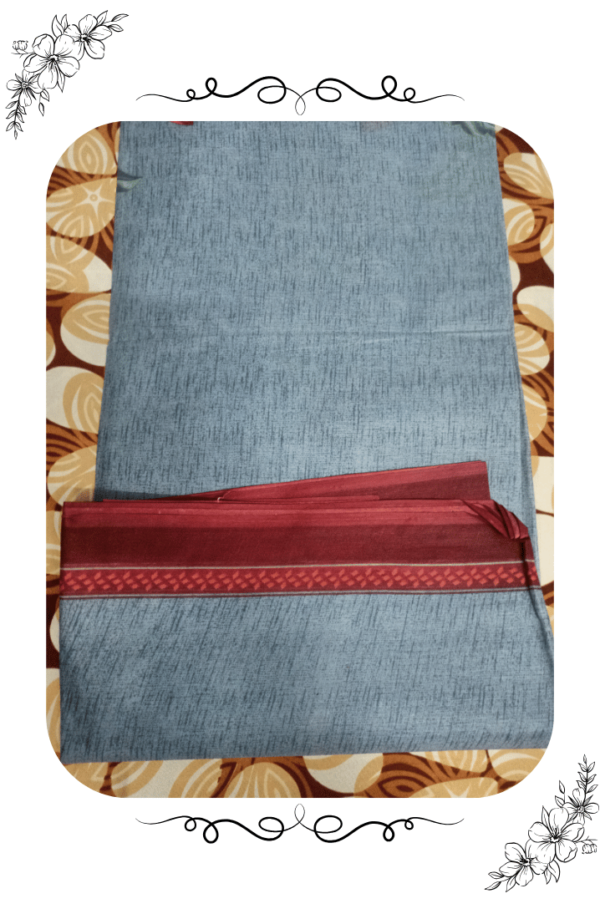 Close-up of red designer border on grey saree
